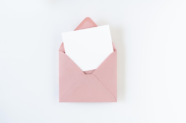 Pink envelope with card on white background