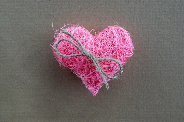 Pink fabric heart shape on the natural background