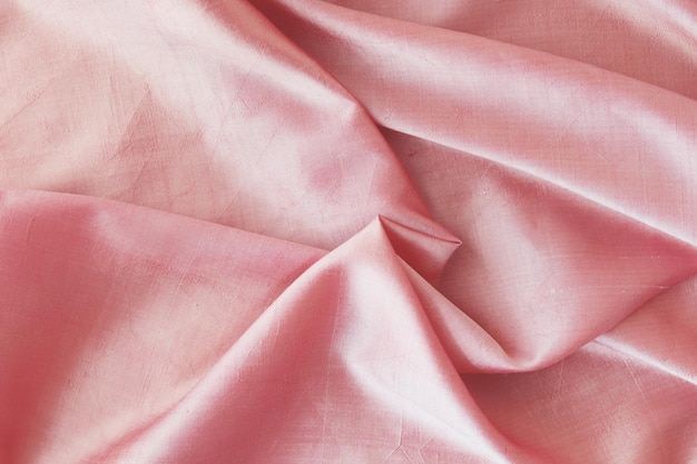 Pink fabric natural silk lined with folds top view background for romantic congratulations