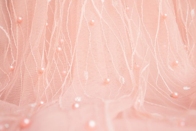 Pink fabric textile decorated with beades and pearls