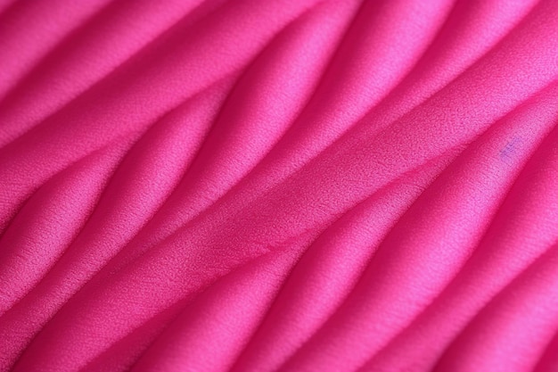 A pink fabric that is textured and has a pattern of curves