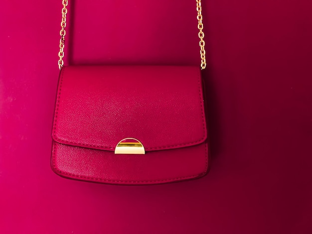 Pink fashionable leather purse with gold details as designer\
bag and stylish accessory female fashion and luxury style handbag\
collection concept