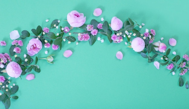 Pink flowers and green leaves on green background