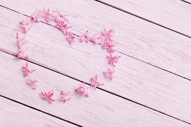 Pink flowers hyacinths on wooden table