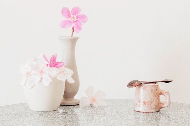 Pink flowers in a vase and cup of coffee
