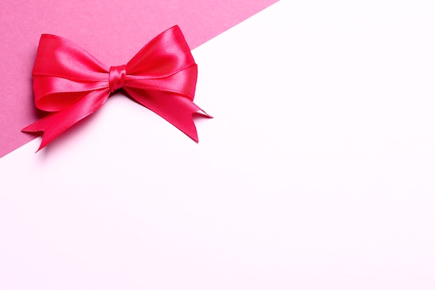 Pink gift bow on a pink background