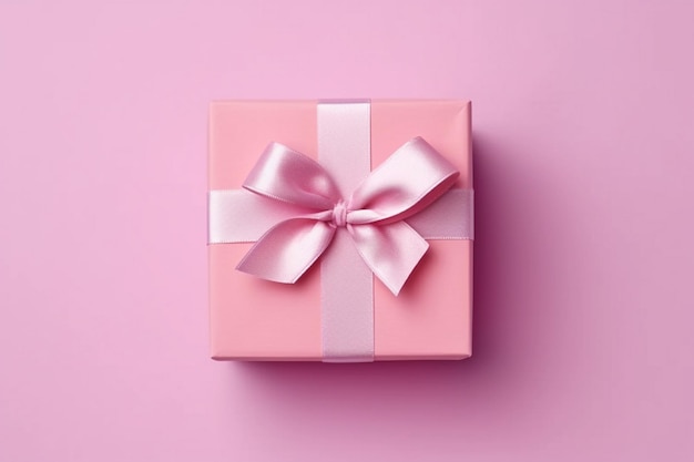 A pink gift box with a pink ribbon and a bow on it.