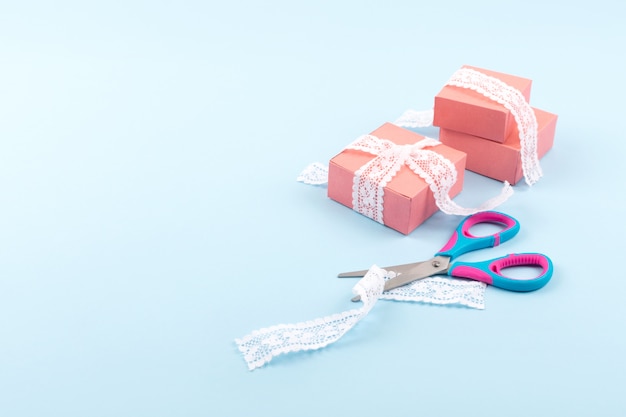 Pink gift boxes with lace and scissors 