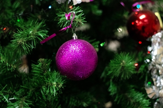 Pink glass ball on a new year fir