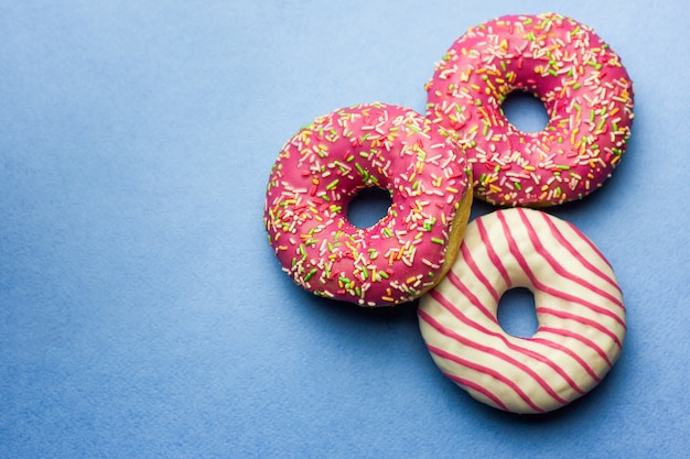 pink glazed donuts on blue background