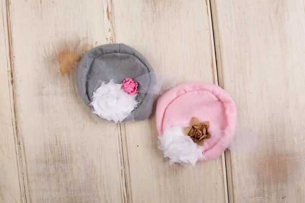 A pink and gray felt hat with a flower on it