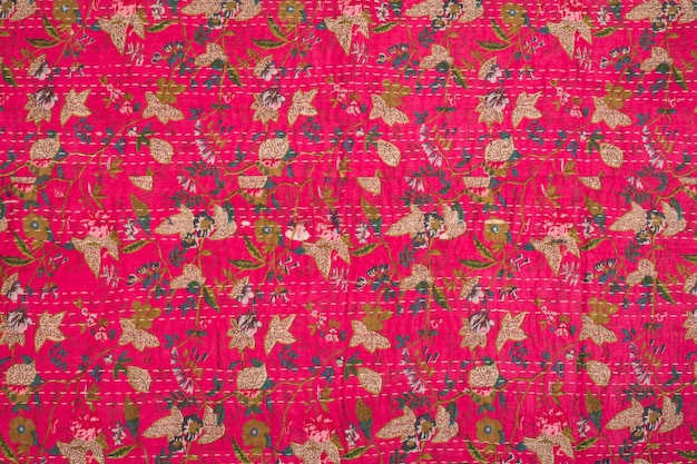 A pink and green fabric with a floral pattern.