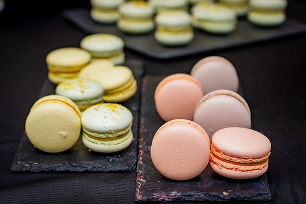 Pink and green macarons on the board