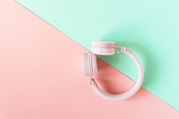 Pink headphones on mint green and pink background