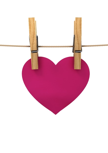 Photo pink heart hanging on a string pinned with clothespins