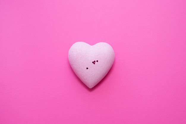 Pink heart on pink background.