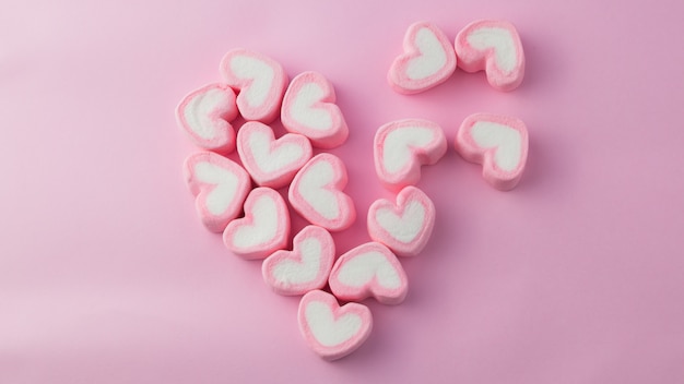 Pink heart-shaped marshmallow in with pink background  