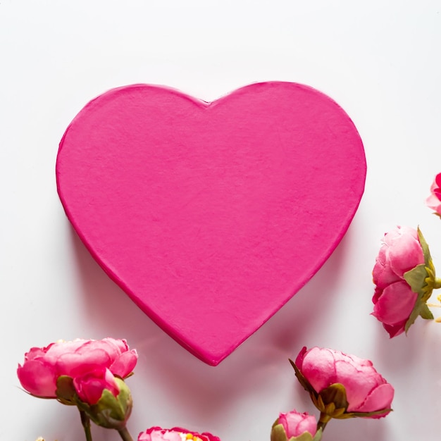 Pink heart for valentines day on a background of flowers