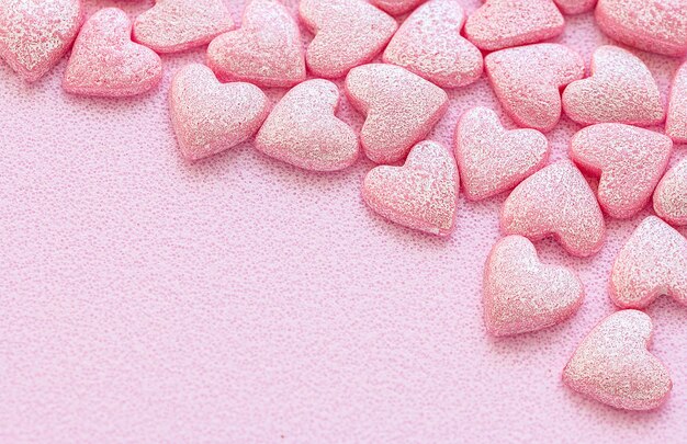 Pink Hearts Shape Candy on pink surfase