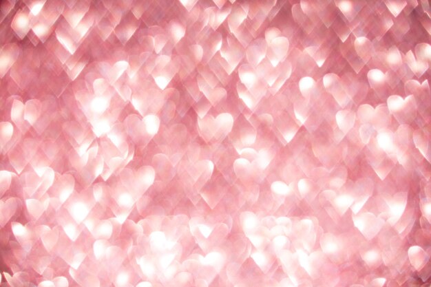 Pink hearts sparkling bokeh abstract defocused background for Valentines Day