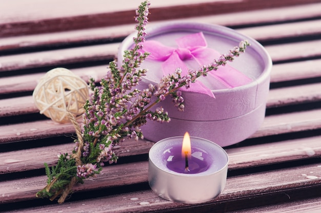 Pink heather, purple lit candle