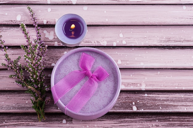 Pink heather, purple lit candle