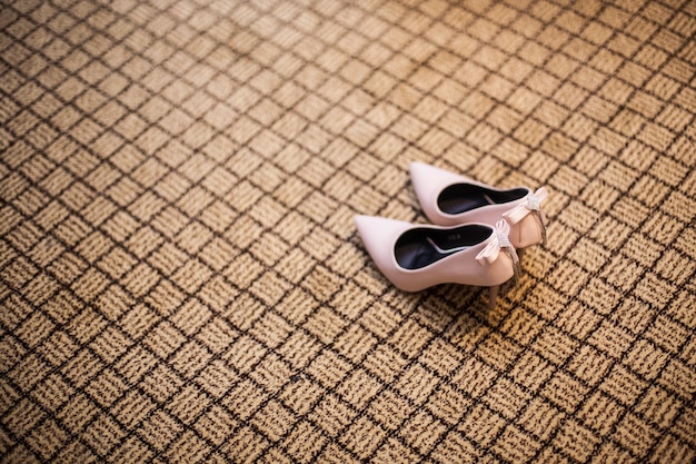 pink high-heel shoes on carpet in wedding 