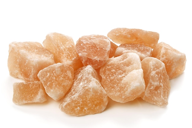 Pink himalayan salt stones on white background