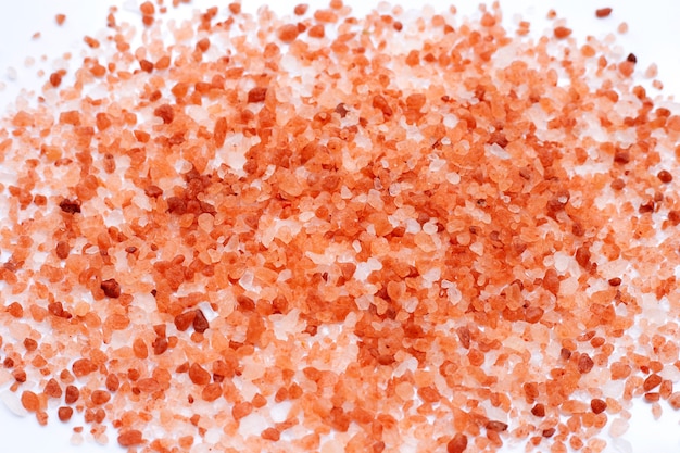 Photo pink himalayan salt on white.