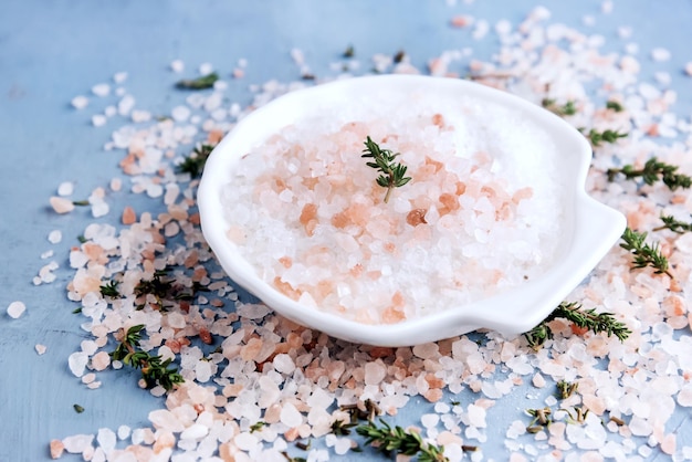 Pink himalayan salt with herb Blue background