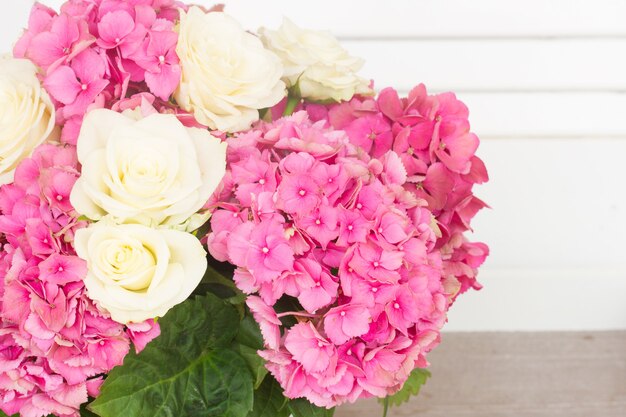 Pink hortensia flowers with white roses close up