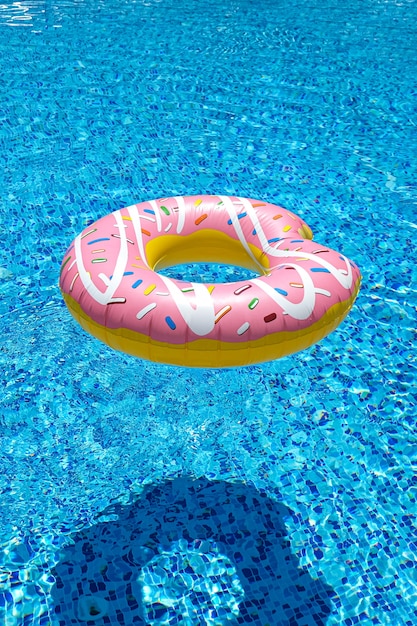 Pink inflatable donut doughnut  in swimming pool