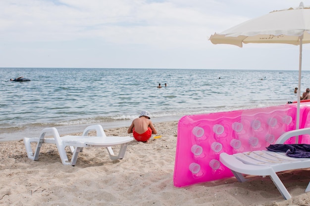 Pink inflatable mattress on the seashore