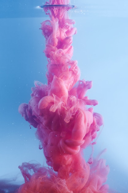 Pink ink in clear blue water