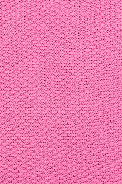 Pink knitted fabric pearl woolen background The structure of the fabric with a natural texture Fabric background Knitted woolen background