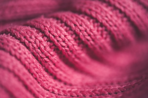 Pink knitted textile closeup. Winter season. Selective focus.