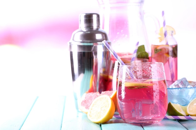 Pink lemonade in glasses and pitcher on table closeup