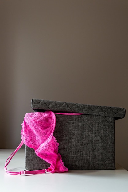 Photo pink lingerie in an ajar dark box