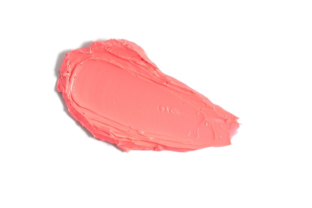 Pink lipstick smudge on white background. Mat lipstick texture. Cosmetic product sample