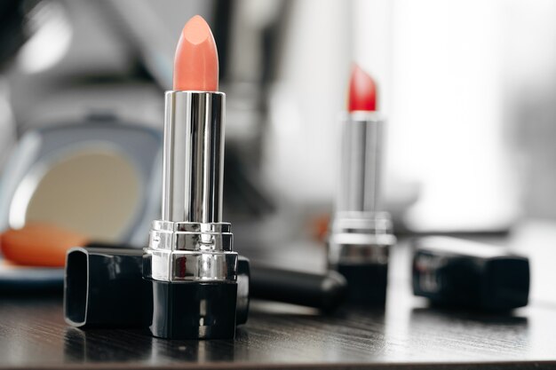 Pink lipstick on vanity table close up