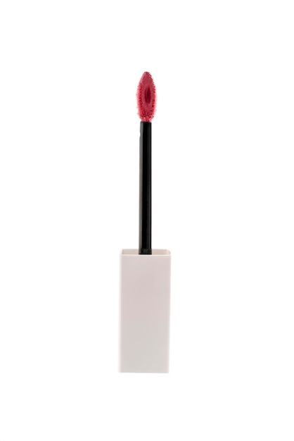 Photo pink liquid lipstick applicator brush on brright background