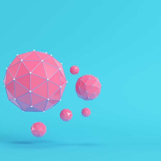 Pink low poly abstract spheres on bright blue background