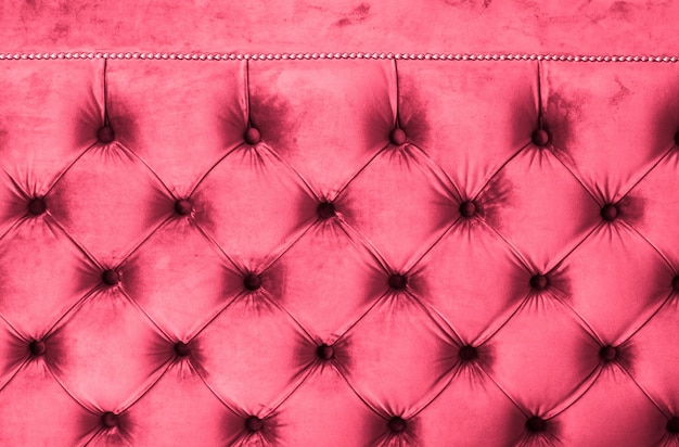 Pink luxury velour quilted sofa upholstery with buttons elegant home decor texture and background