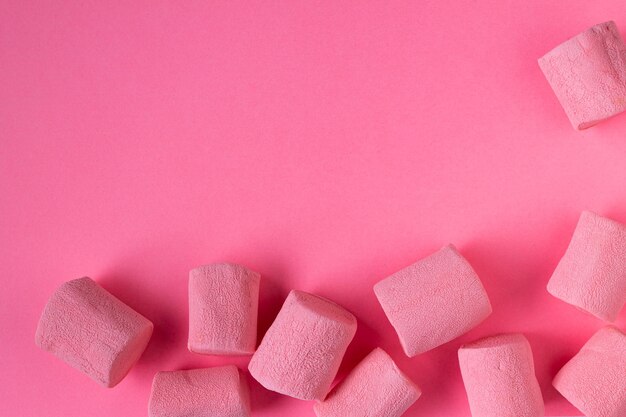 Pink marshmallow on a pink background, selective focus