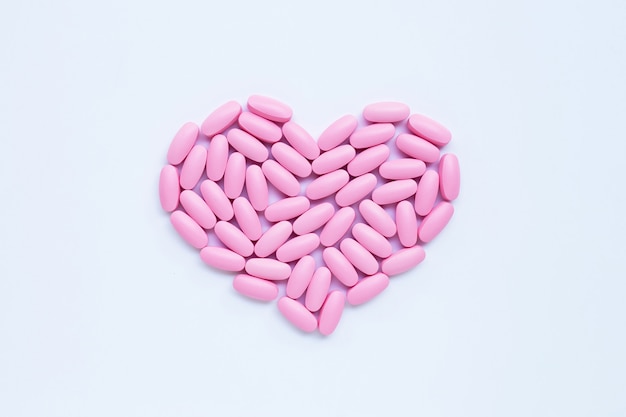 Pink medicine pills on white background.