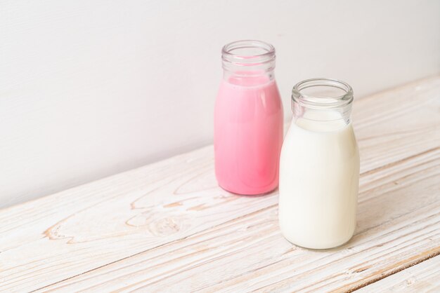 pink milk or strawberry milk with fresh milk in bottle