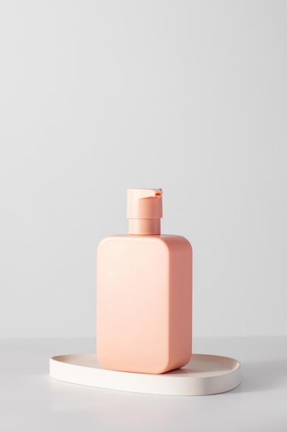 A pink mockup of a cosmetic product with a place for a logo shampoo gel