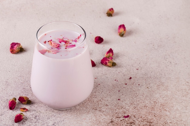 pink moon milk in glass, midnight relaxing drink, roses, pink table