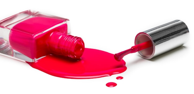 Pink nail polish bottle on white background