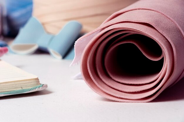 Pink Nonreal leather fabric roll on manual work table